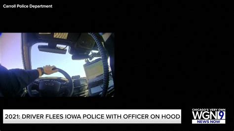 Video shows driver fleeing Iowa police with officer on hood, roof of car